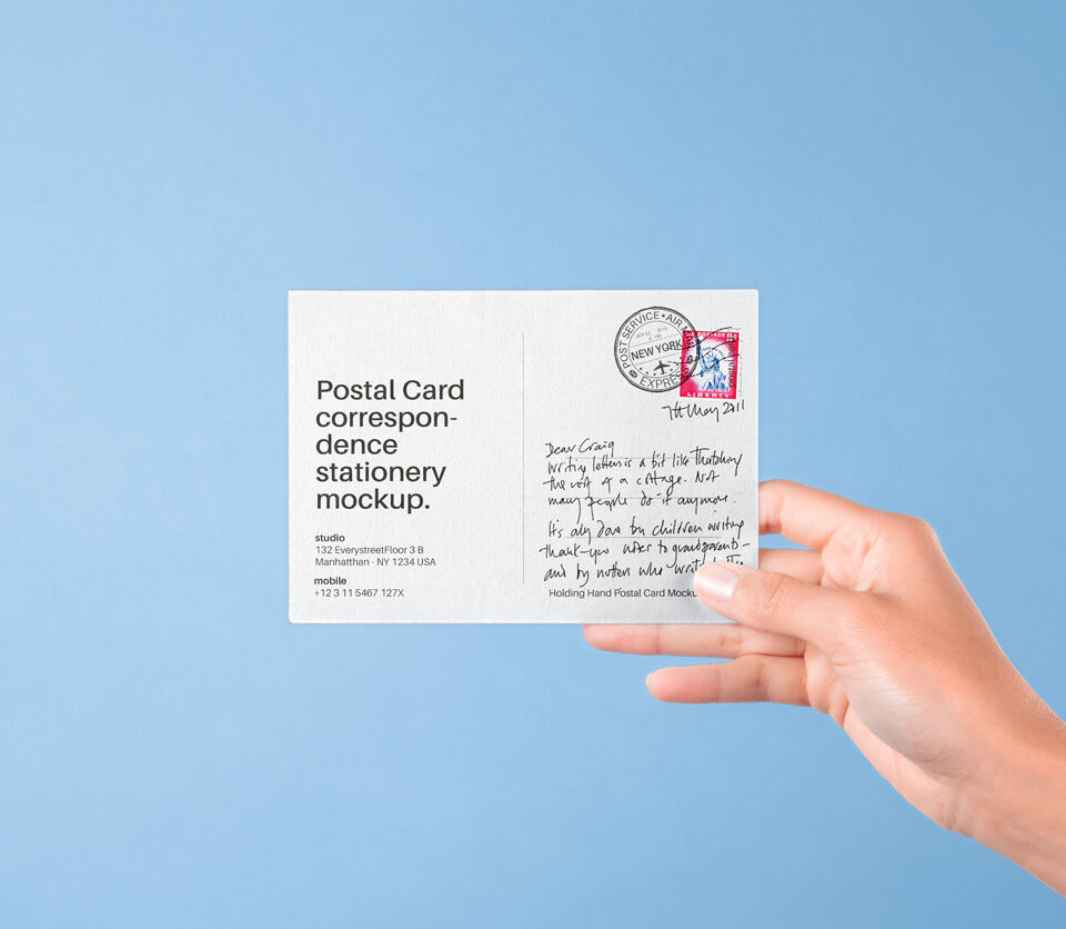 Front View of Hand Holding Postal Card Mockup