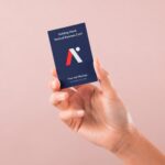 Front View of Hand Holding Vertical Business Card Mockup