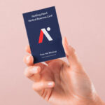 Front View of Hand Holding Vertical Business Card Mockup