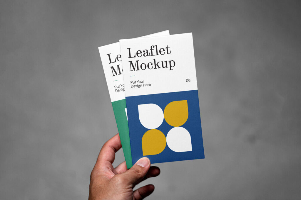 Front View of Hand Holding Vertical Leaflets Mockup