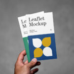 Front View of Hand Holding Vertical Leaflets Mockup