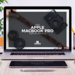 Front View of MacBook Pro and Stationery Items Mockup