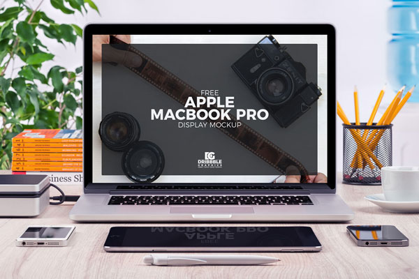 Front View of MacBook Pro and Stationery Items Mockup