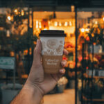 Front View of Man Holding Paper Cup Mockup