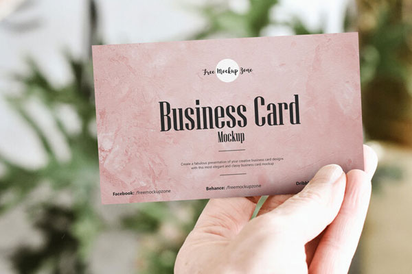 Front View of Man’s Hand Showing a Business Card Mockup