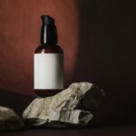 Front View of Mini Foam Pump Bottle Mockup above Real Rocks