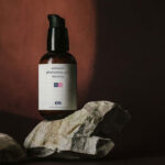 Front View of Mini Foam Pump Bottle Mockup above Real Rocks
