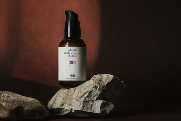 Front View of Mini Foam Pump Bottle Mockup above Real Rocks