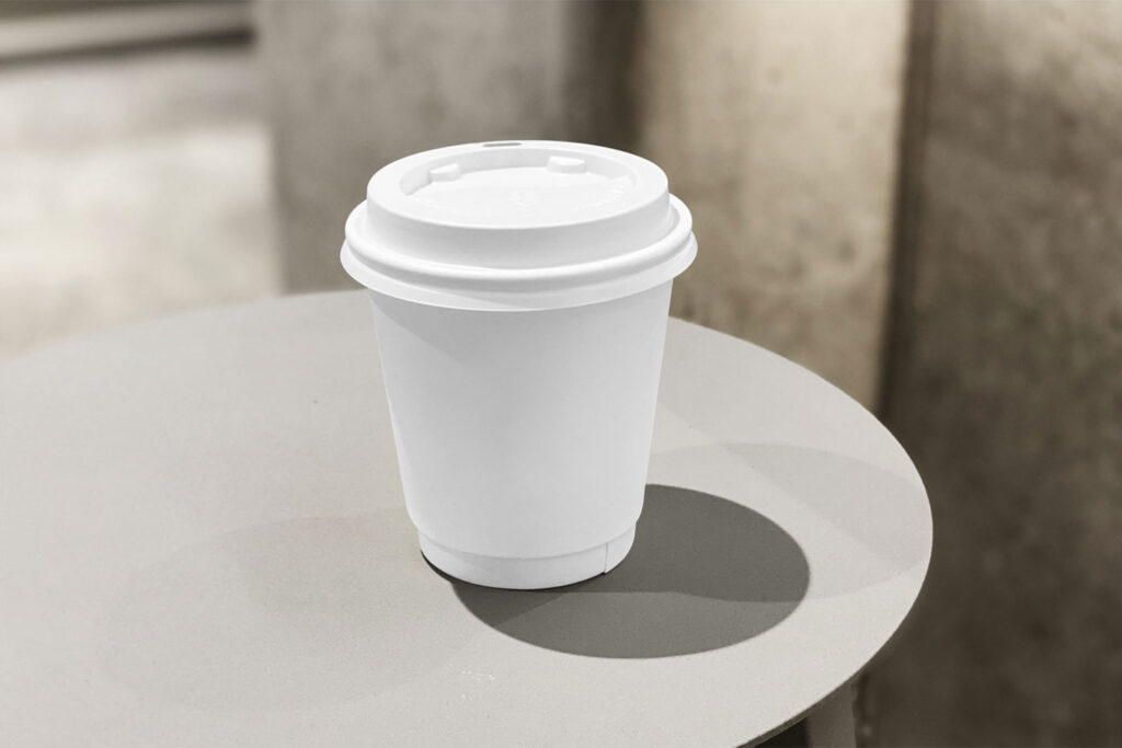 Front View of Small Coffee Cup Mockup on Table