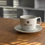 Front View of Tea Cup Mockup on Wooden Desk