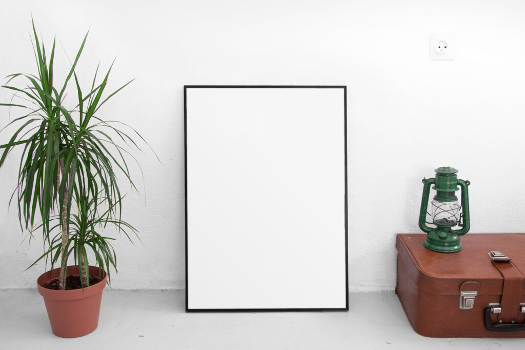 Front View of Vertical Poster Frame Mockup with Plant