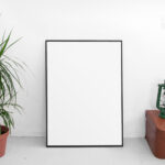 Front View of Vertical Poster Frame Mockup with Plant
