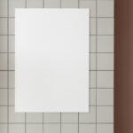 Front View of Vertical Poster Mockup on Wall