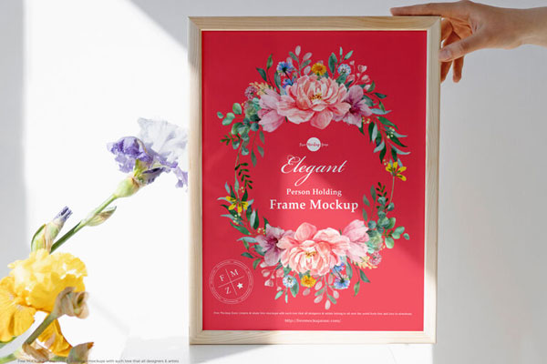 Front View Person Holding Wooden Frame with Flowers Mockup