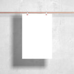 Front View Poster Hanging from Metal Bar Against Wall Mockup