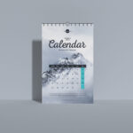 Front View Vertical Wall Calendar Mockup Standing Against the Wall