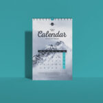 Front View Vertical Wall Calendar Mockup Standing Against the Wall
