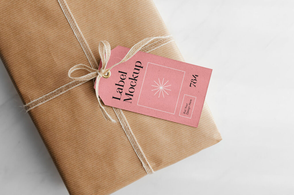 Gift Card Mockup Hung From Wrapped Package in Top View