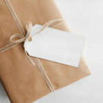 Gift Card Mockup Hung From Wrapped Package in Top View