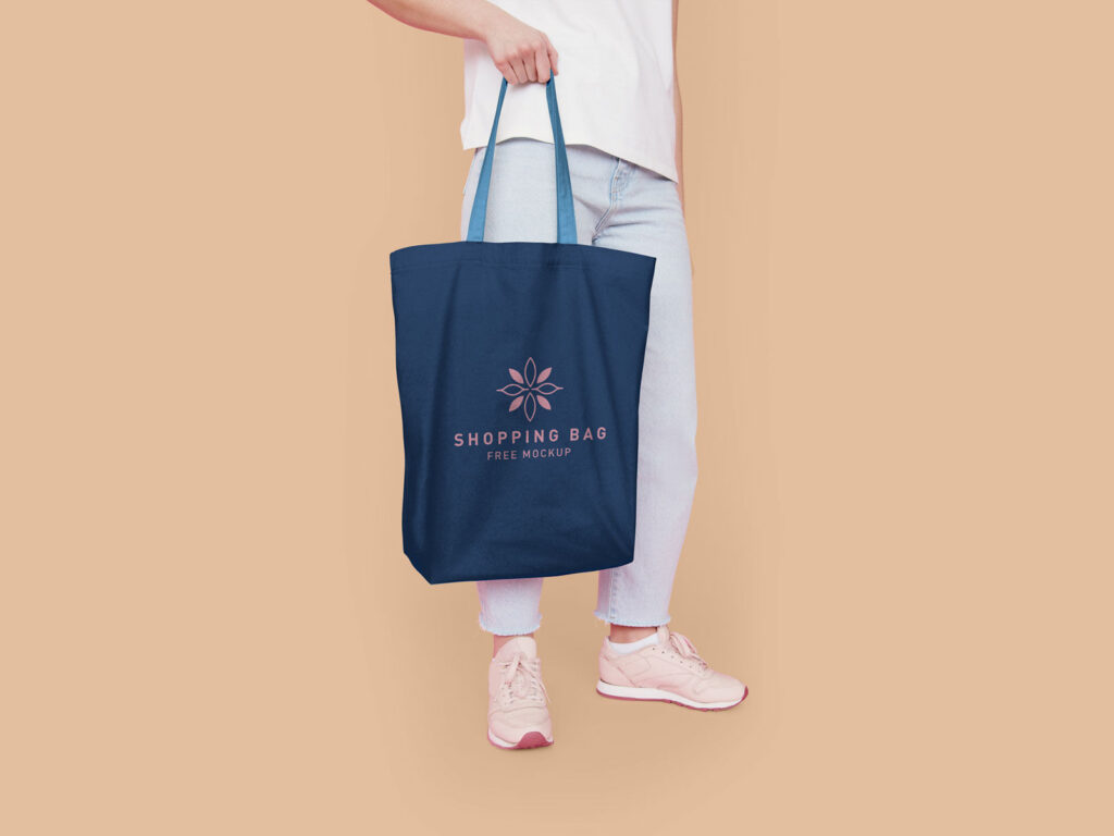 Half-Side View Cotton Tote Bag Featuring Someone Holding It Mockup