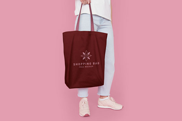 Half-Side View Cotton Tote Bag Featuring Someone Holding It Mockup
