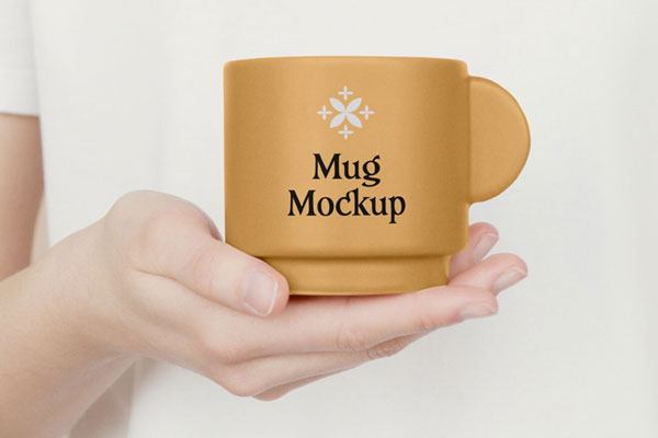Hand Holding a Ceramic Mug Mockup