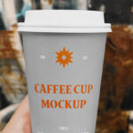 Hand Holding a Coffee Cup on a Street Mockup