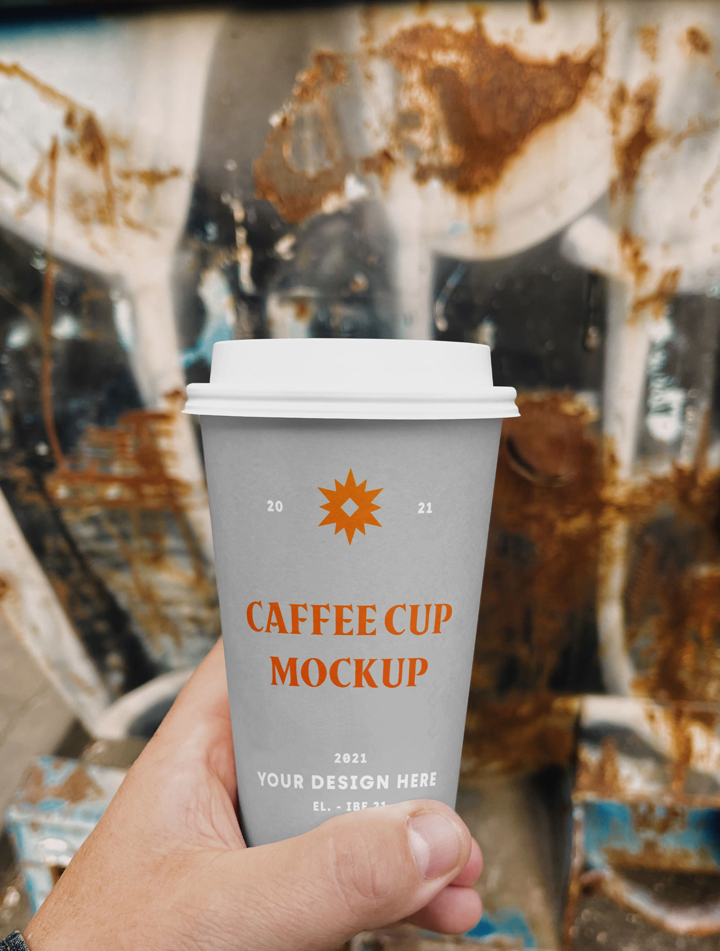 Hand Holding a Coffee Cup on a Street Mockup FREE PSD