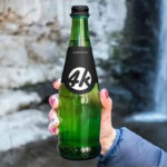 Hand Holding a Long Neck Glass Bottle Mockup