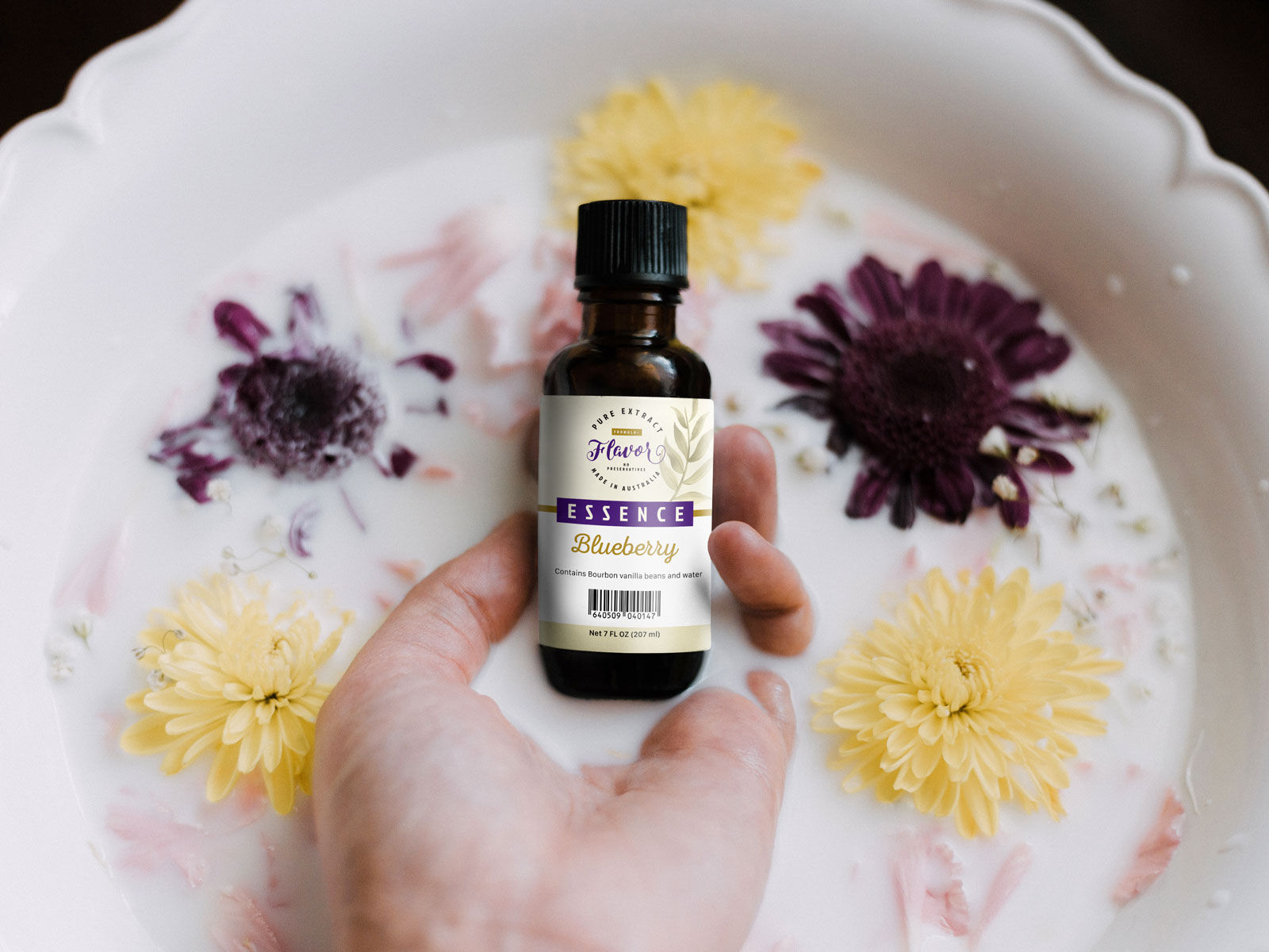 Hand Holding Food Essence Bottle with Milk and Flower around Mockup FREE PSD