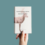 Hand Holding Hardcover Book Mockup