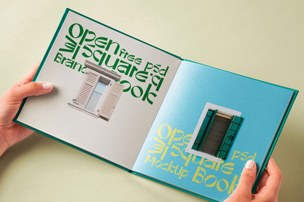Hand Holding Hardcover Open Book Mockup in Perspective View
