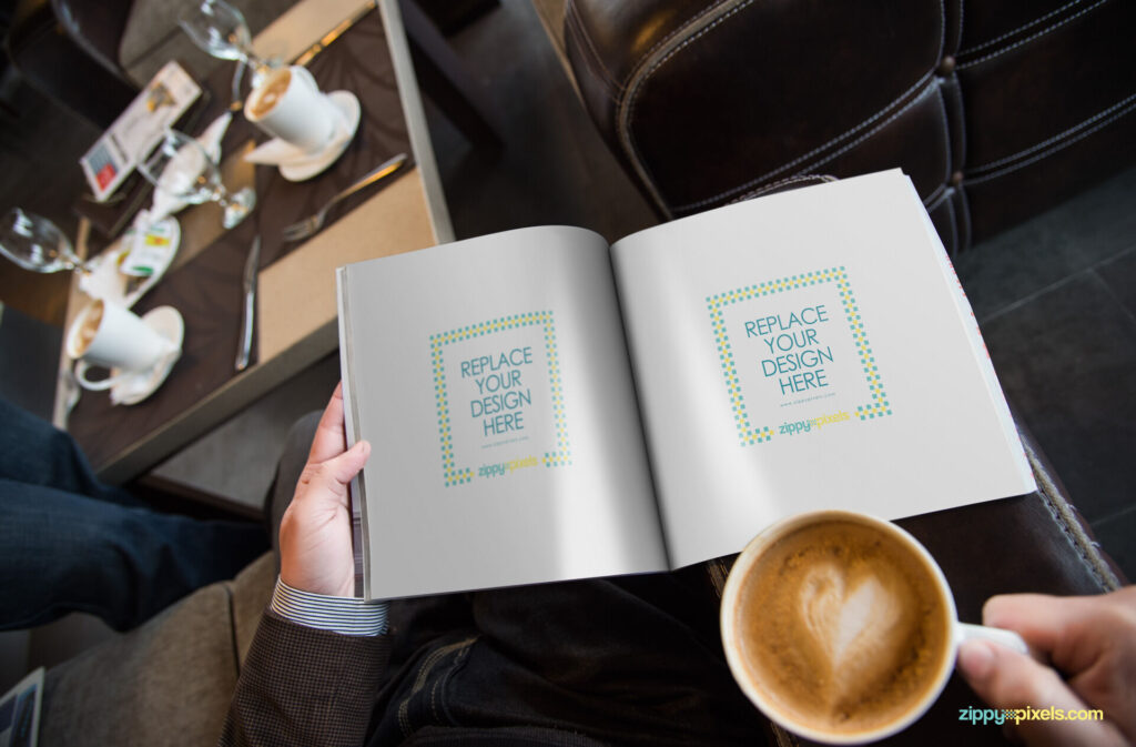 Hand Holding Open Magazine Mockup