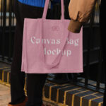 Hand Holding the Realistic Medium Canvas Bag Mockup