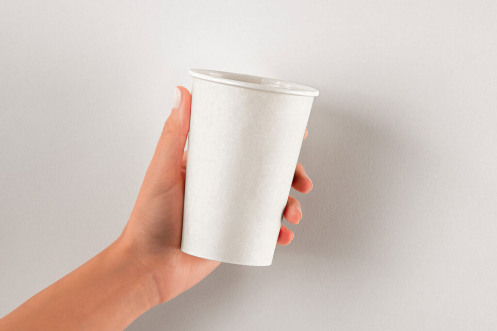 Hands Holding Paper Hot Cup Mockup in Front View