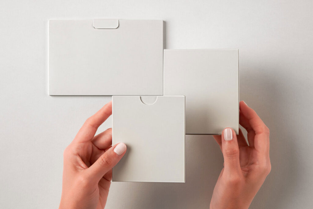 Hands Holding Product Boxes Mockup in Top Sight