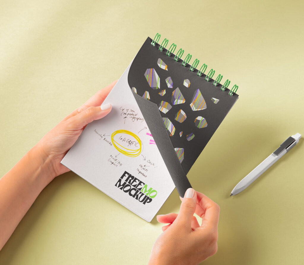Hands Holding Spiral Notebook Mockup in Perspective Sight