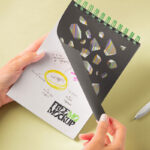 Hands Holding Spiral Notebook Mockup in Perspective Sight