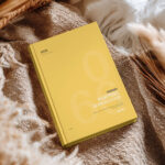 Hardcover Book Cover Mockup on Cozy Fabric Scene