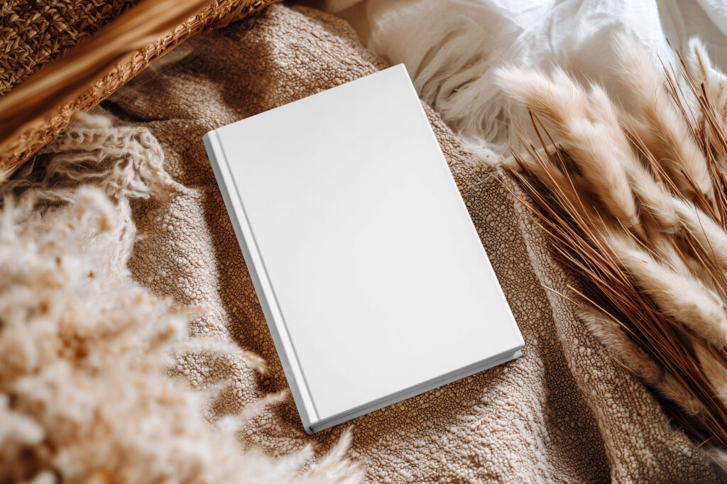 Hardcover Book Cover Mockup on Cozy Fabric Scene