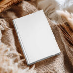 Hardcover Book Cover Mockup on Cozy Fabric Scene