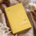Hardcover Book Cover Mockup on Cozy Fabric Scene