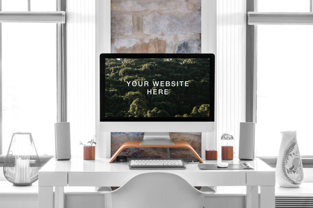 Hyper Realistic iMac on a Desk in a Room Front View Mockup