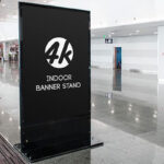 Indoors, Vertical Banner Stand in the Half-Side View Mockup
