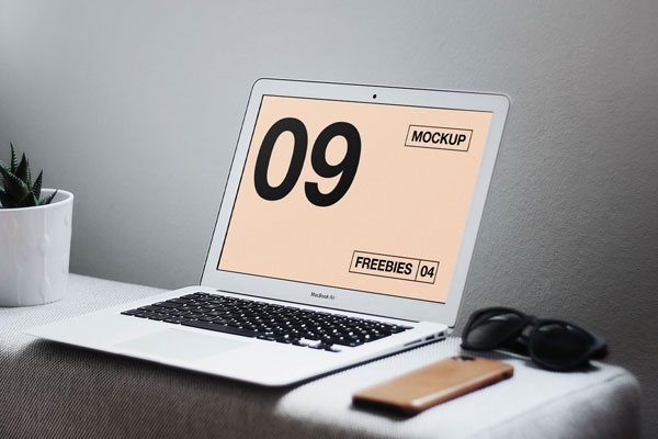 Interior View of MacBook on Table with Related Items Mockup