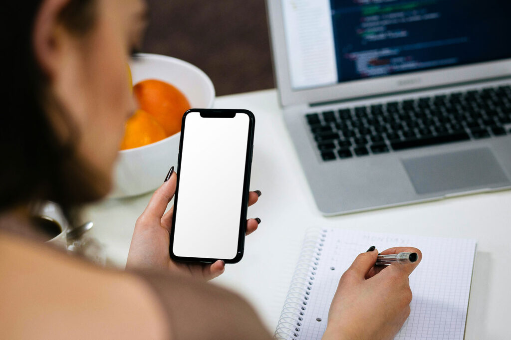 iPhone in Woman Hand Mockup
