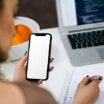 iPhone in Woman Hand Mockup