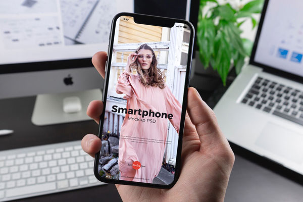 iPhone X Grabbed by Man’s Hand in the Front View Mockup