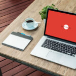Laptop Mockup on Wooden Desk Outdoor at a 34 Angle View