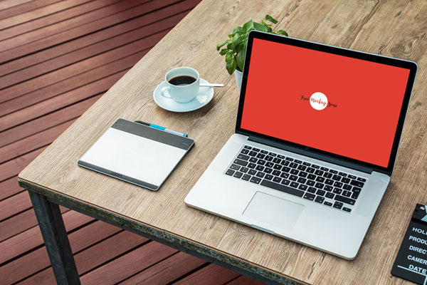 Laptop Mockup on Wooden Desk Outdoor at a 3\4 Angle View